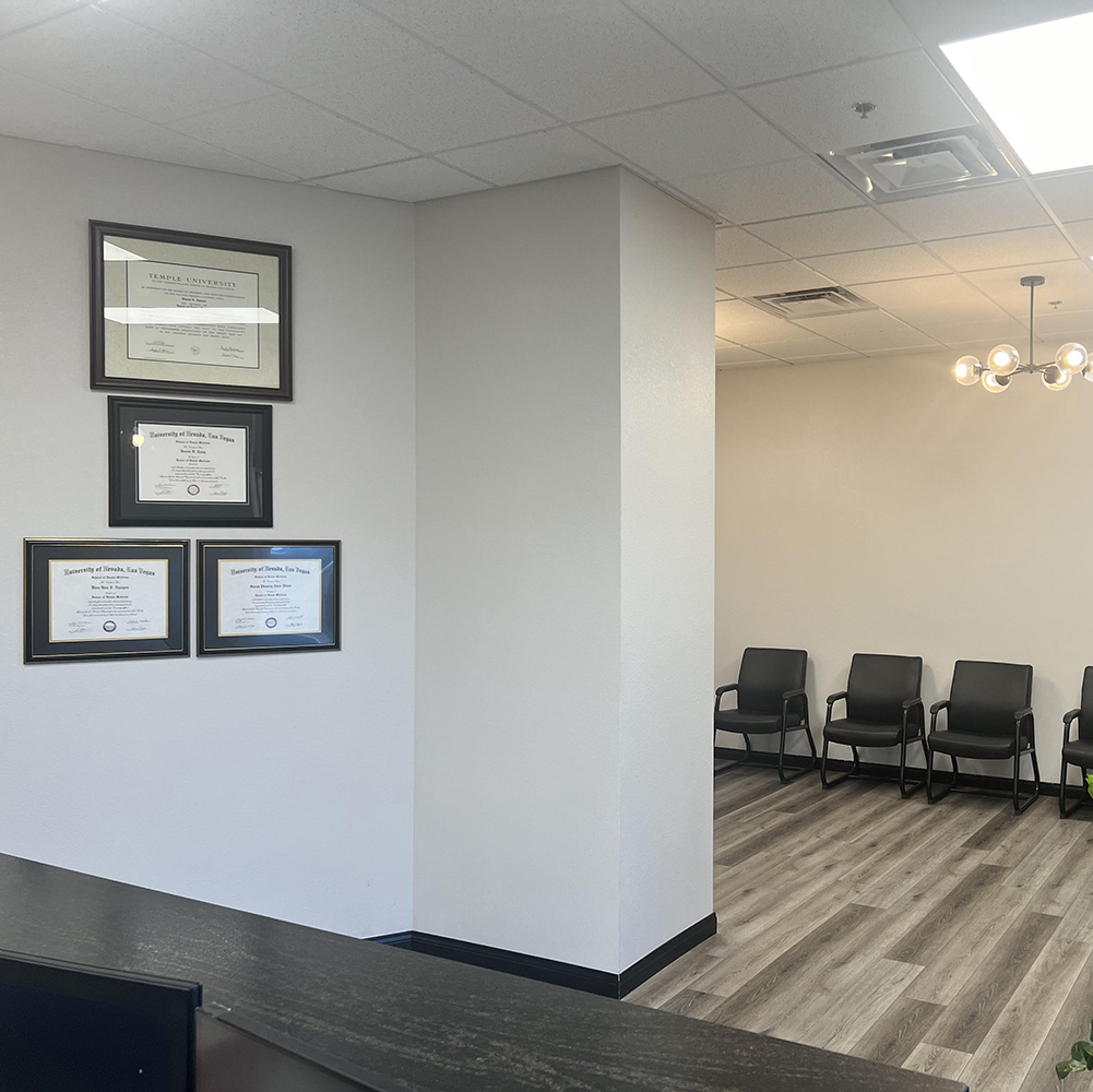 The image shows a modern office space with a sleek desk, chair, and computer setup, featuring wood paneling, a white countertop, and a contemporary design.