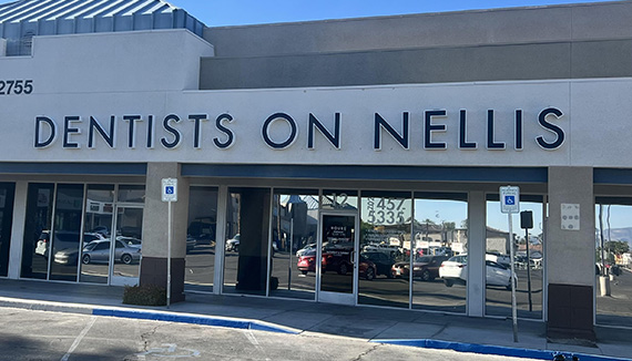 The image shows a sign for  Dentists on Nellis  with the name of the establishment prominently displayed in large, capitalized letters.